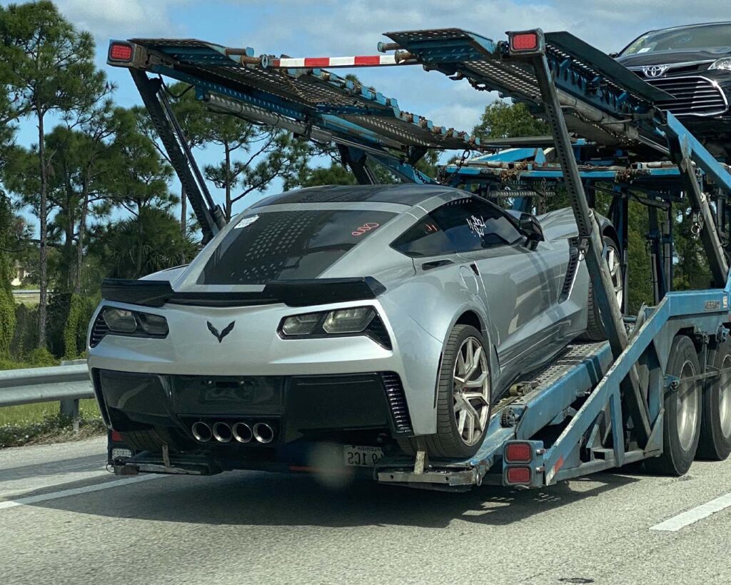 Sports car on an open car carrier trailer